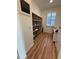Small office space with shelving, a desk, wood floors, and a shuttered window at 5235 Nw 33Rd Pl, Ocala, FL 34482
