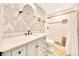 Elegant bathroom with patterned wallpaper, vanity with marble countertop, and a walk-in shower at 5581 Se 35Th St, Ocala, FL 34480