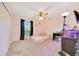 Bright bedroom featuring a bed, ceiling fan, closet and a window at 5581 Se 35Th St, Ocala, FL 34480