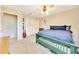 Bedroom showcasing a green bed frame, carpet, ceiling fan and large closet at 5581 Se 35Th St, Ocala, FL 34480