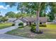 Cozy single-Gathering house with a lush front yard, mature trees, and an attached garage, perfect for suburban living at 5581 Se 35Th St, Ocala, FL 34480