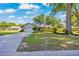 Inviting home featuring a green lawn, mature trees, and a convenient attached garage, ideal for Gathering living at 5581 Se 35Th St, Ocala, FL 34480