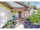 Inviting front porch area with a cozy chair, potted plants, and decorative wreath, perfect for relaxation at 5581 Se 35Th St, Ocala, FL 34480
