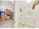 Combined laundry room and living space with modern appliances, wood look floors and ample space at 5581 Se 35Th St, Ocala, FL 34480