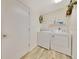 Functional laundry room featuring modern appliances and wood look floors at 5581 Se 35Th St, Ocala, FL 34480