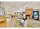 Spacious living room with a brick fireplace, tile flooring, and natural light, ideal for entertaining at 5581 Se 35Th St, Ocala, FL 34480