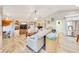 Bright living room featuring wood floors, built-in shelving, and comfortable seating for a welcoming space at 5581 Se 35Th St, Ocala, FL 34480