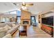 Cozy living room with a brick fireplace, tile flooring, and comfortable seating, perfect for relaxation at 5581 Se 35Th St, Ocala, FL 34480