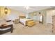 Cozy main bedroom featuring a sitting area, wood accents, soft carpet, and natural light at 5581 Se 35Th St, Ocala, FL 34480