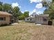 Large backyard featuring multiple storage sheds and a spacious grassy area at 5915 Se Holly Rd, Belleview, FL 34420