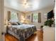 Comfortable bedroom with hardwood floors, a ceiling fan, and a queen-sized bed at 5915 Se Holly Rd, Belleview, FL 34420