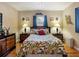 Bedroom featuring hardwood floors, a ceiling fan, and dual nightstands at 5915 Se Holly Rd, Belleview, FL 34420
