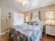 Bedroom featuring hardwood floors, a ceiling fan, and a queen-sized bed at 5915 Se Holly Rd, Belleview, FL 34420