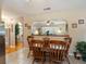 Open dining area with wood table and chairs, arched pass-through to living room at 5915 Se Holly Rd, Belleview, FL 34420