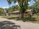 Charming single-story home with a welcoming front porch and mature landscaping at 5915 Se Holly Rd, Belleview, FL 34420