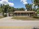 Charming home featuring a covered front porch and spacious front yard at 5915 Se Holly Rd, Belleview, FL 34420