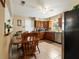 Functional kitchen with wooden cabinetry, tiled flooring and adjacent dining area at 5915 Se Holly Rd, Belleview, FL 34420