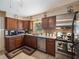 Well-lit kitchen features wooden cabinetry, stainless steel appliances, and granite countertops at 5915 Se Holly Rd, Belleview, FL 34420