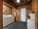 Functional laundry room with washer, dryer, and wood paneling at 5915 Se Holly Rd, Belleview, FL 34420