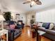 Comfortable living room featuring hardwood floors, neutral walls, and cozy furniture at 5915 Se Holly Rd, Belleview, FL 34420