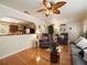 Comfortable living room featuring hardwood floors, neutral walls, and cozy furniture at 5915 Se Holly Rd, Belleview, FL 34420
