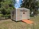 Exterior view of the shed with a window box and convenient ramp access at 5915 Se Holly Rd, Belleview, FL 34420