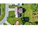 Aerial view showcasing home's metal roof, large lawn, landscaping and neighboring homes at 6142 Se 37Th Ter, Ocala, FL 34480