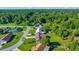 Aerial view showcases the home surrounded by lush greenery, other homes, and a river at 6142 Se 37Th Ter, Ocala, FL 34480