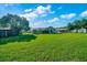 Vast backyard with lush greenery, privacy fence, and partial home view at 6142 Se 37Th Ter, Ocala, FL 34480