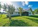 Lush backyard view featuring well-maintained lawn and partial home exterior at 6142 Se 37Th Ter, Ocala, FL 34480