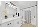 Stylish bathroom featuring a modern vanity, quartz countertops, updated fixtures, and shower at 6142 Se 37Th Ter, Ocala, FL 34480