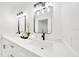 Modern bathroom showcasing double sink vanity with quartz counters, sleek fixtures, and white shiplap walls at 6142 Se 37Th Ter, Ocala, FL 34480