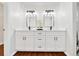 Bathroom with double vanity, white cabinets, and modern fixtures at 6142 Se 37Th Ter, Ocala, FL 34480
