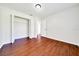 Large bedroom featuring wood look floors, neutral paint, closet, and a window at 6142 Se 37Th Ter, Ocala, FL 34480