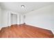 Spacious bedroom with wood-look flooring and folding closet doors at 6142 Se 37Th Ter, Ocala, FL 34480