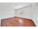 Bright bedroom with wood floors, a window, and a closet with sliding doors at 6142 Se 37Th Ter, Ocala, FL 34480