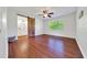 Bedroom with hardwood floors, ceiling fan, and a barn door leading to the bathroom at 6142 Se 37Th Ter, Ocala, FL 34480