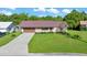 Inviting single-story brick home featuring a well-kept lawn and a durable metal roof at 6142 Se 37Th Ter, Ocala, FL 34480