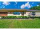 Attractive brick home featuring manicured landscaping, a green lawn, and a garage door at 6142 Se 37Th Ter, Ocala, FL 34480