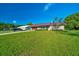 This home features a metal roof, brick and concrete exterior, and a manicured lawn at 6142 Se 37Th Ter, Ocala, FL 34480