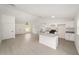 Bright, open-concept living space with white cabinets, granite counters and bar top at 681 Sw Fig Tree Ln, Dunnellon, FL 34431