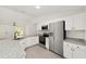 Modern kitchen with stainless steel appliances, granite countertops, and white cabinets at 732 Sw Fig Tree Ln, Dunnellon, FL 34431