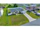 Aerial view of home showing the expansive green lawn, fenced yard, and long driveway at 7327 Sw 129Th Ln, Ocala, FL 34473