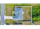 Overhead view of backyard with patio and firepit, green lawn and fenced border at 7327 Sw 129Th Ln, Ocala, FL 34473