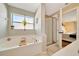 Modern bathroom features a large soaking tub with plant, and a standing shower at 7327 Sw 129Th Ln, Ocala, FL 34473