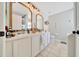 Dual sink bathroom with great lighting, tiled floors, and great mirrors above the sinks at 7327 Sw 129Th Ln, Ocala, FL 34473