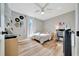 Bright bedroom with ceiling fan, wood floors, lots of natural light, and a desk area at 7327 Sw 129Th Ln, Ocala, FL 34473