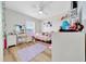 Bright bedroom with ceiling fan, wood floors, lots of natural light, and a makeup vanity at 7327 Sw 129Th Ln, Ocala, FL 34473