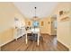 Sunlit dining room with modern chandelier, wood floors, and seating for six at 7327 Sw 129Th Ln, Ocala, FL 34473