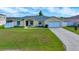 Charming single-story home with a well-maintained lawn and attached two-car garage at 7327 Sw 129Th Ln, Ocala, FL 34473